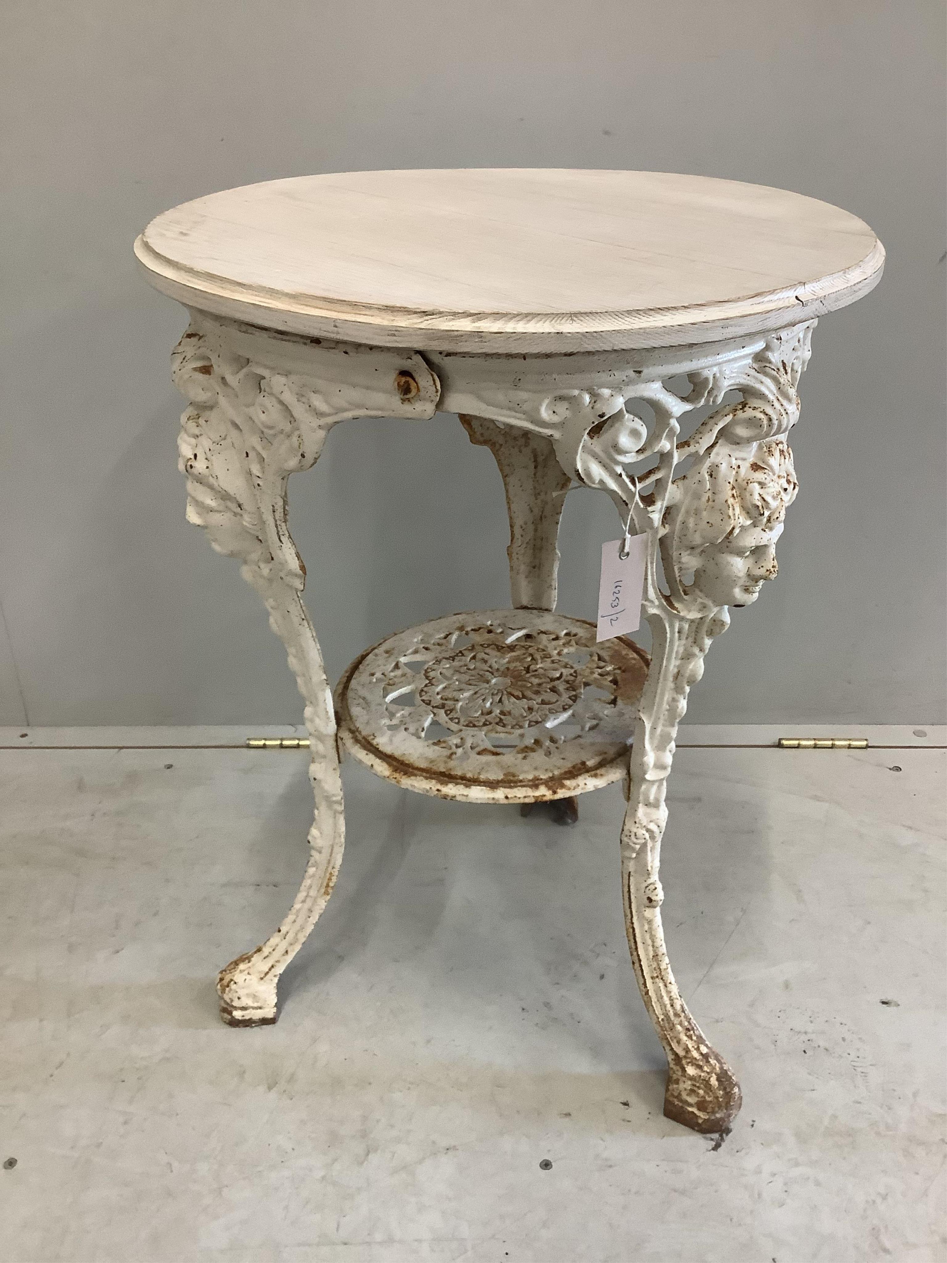 A white painted cast iron circular pub table, with later white stained wooden top, diameter 50cm, height 70cm. Condition - some oxidisation, otherwise good